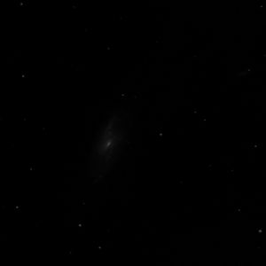Photo of M106 by Richard Arendt modified to show what you might see under washed-out skies